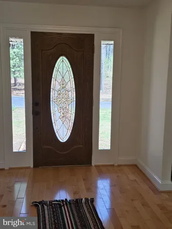 a view of a room with wooden floor and window