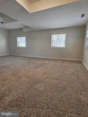a view of empty room with wooden floor and fireplace