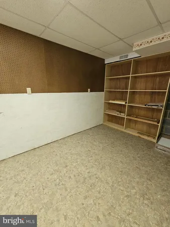 a backyard of a house with large trees and a barn