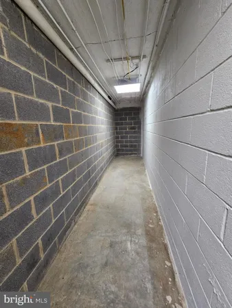 a front view of a house with a yard and large trees