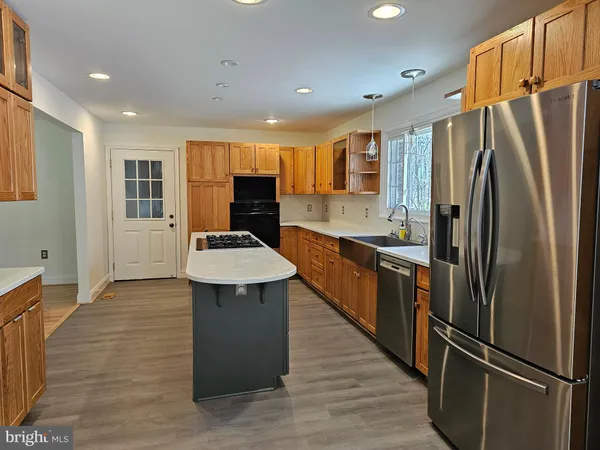 a kitchen with a sink a stove and refrigerator