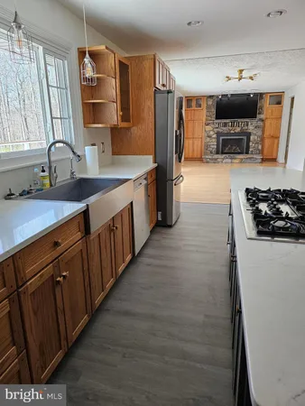 a room with wooden floor and pool table