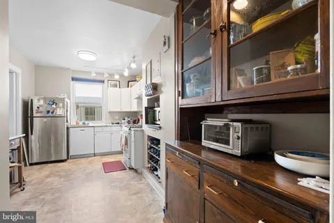 a kitchen with a refrigerator and cabinets