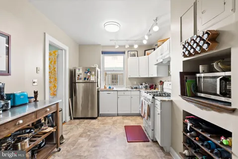 a kitchen with a sink stove and refrigerator