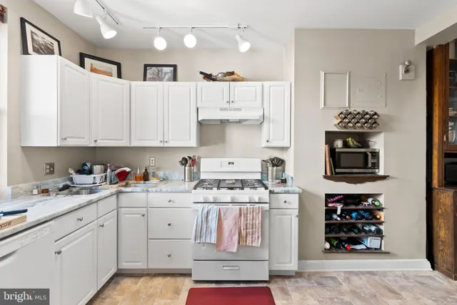 a kitchen with stainless steel appliances kitchen island granite countertop a refrigerator and a stove top oven