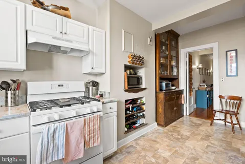 a kitchen with stainless steel appliances a stove a refrigerator and cabinets