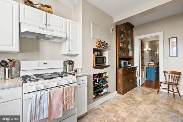 a kitchen with stainless steel appliances a stove a refrigerator and cabinets