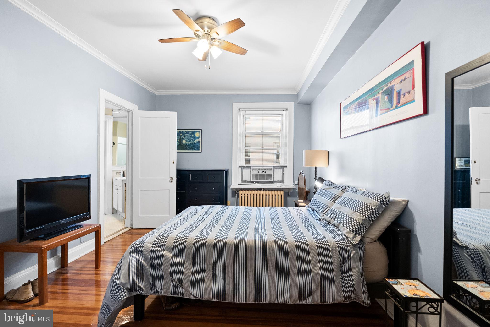 3405 Greenway, Unit 302 Baltimore, MD 21218 - Photo 22 of 42 a bedroom with a bed and a flat screen tv