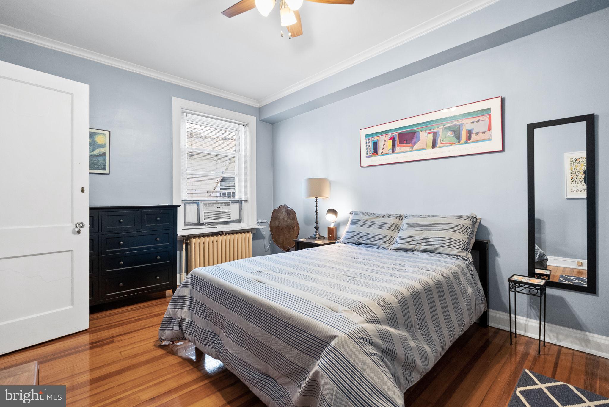 3405 Greenway, Unit 302 Baltimore, MD 21218 - Photo 23 of 42 a bedroom with a bed and a dresser