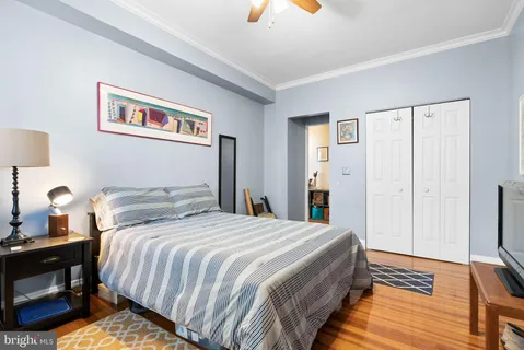 a bedroom with bed and a night stand