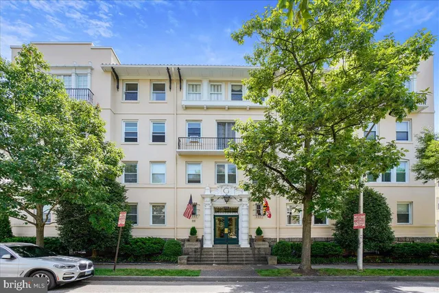 a front view of a residential apartment building with a yard
