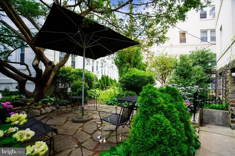 a view of table and chairs under an umbrella