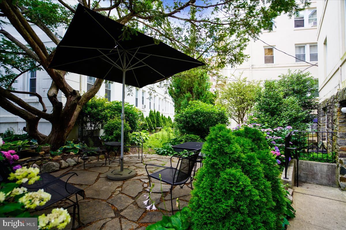 3405 Greenway, Unit 302 Baltimore, MD 21218 - Photo 38 of 42 a view of table and chairs under an umbrella