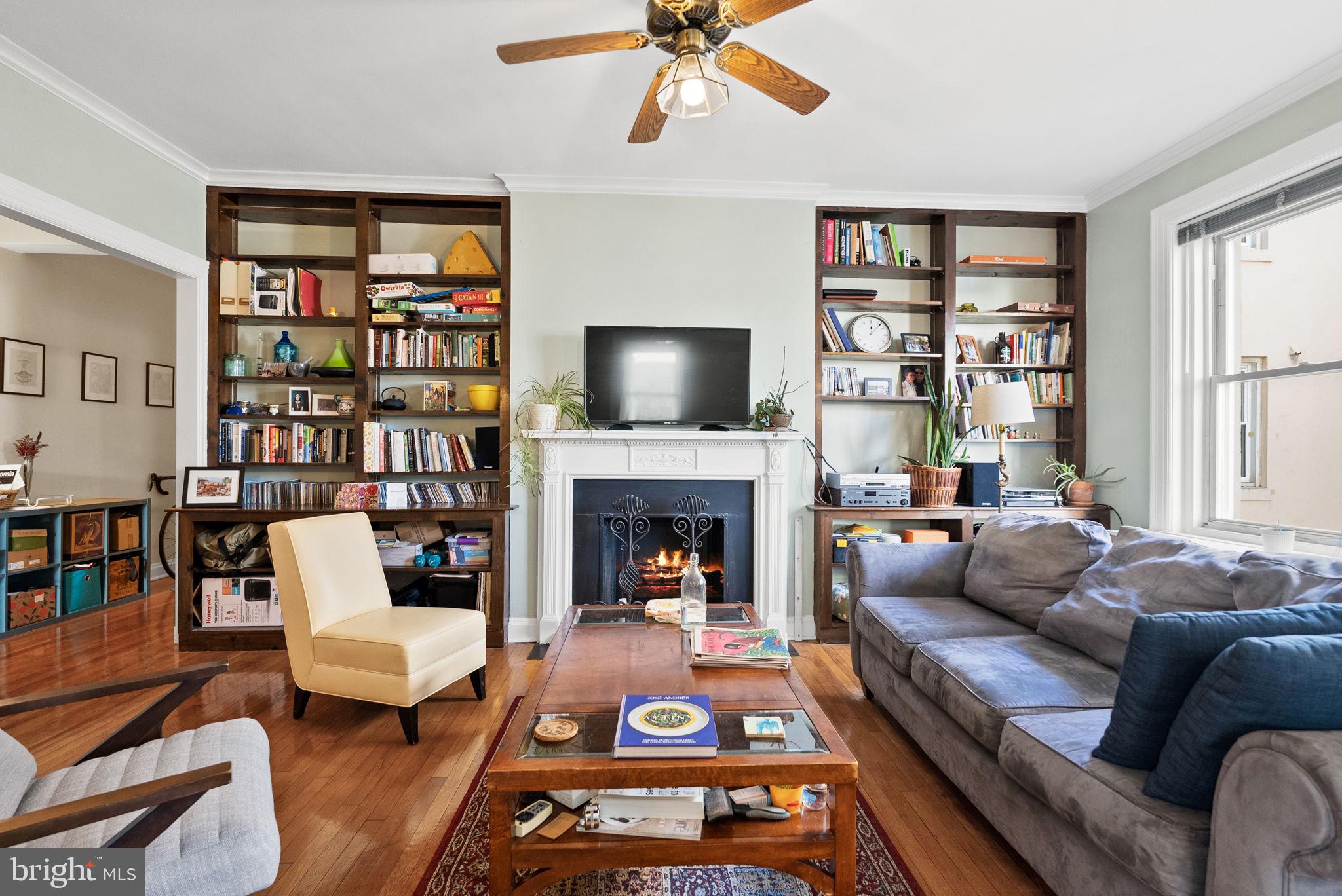 3405 Greenway, Unit 302 Baltimore, MD 21218 - Photo 6 of 42 a living room with furniture fireplace and a flat screen tv