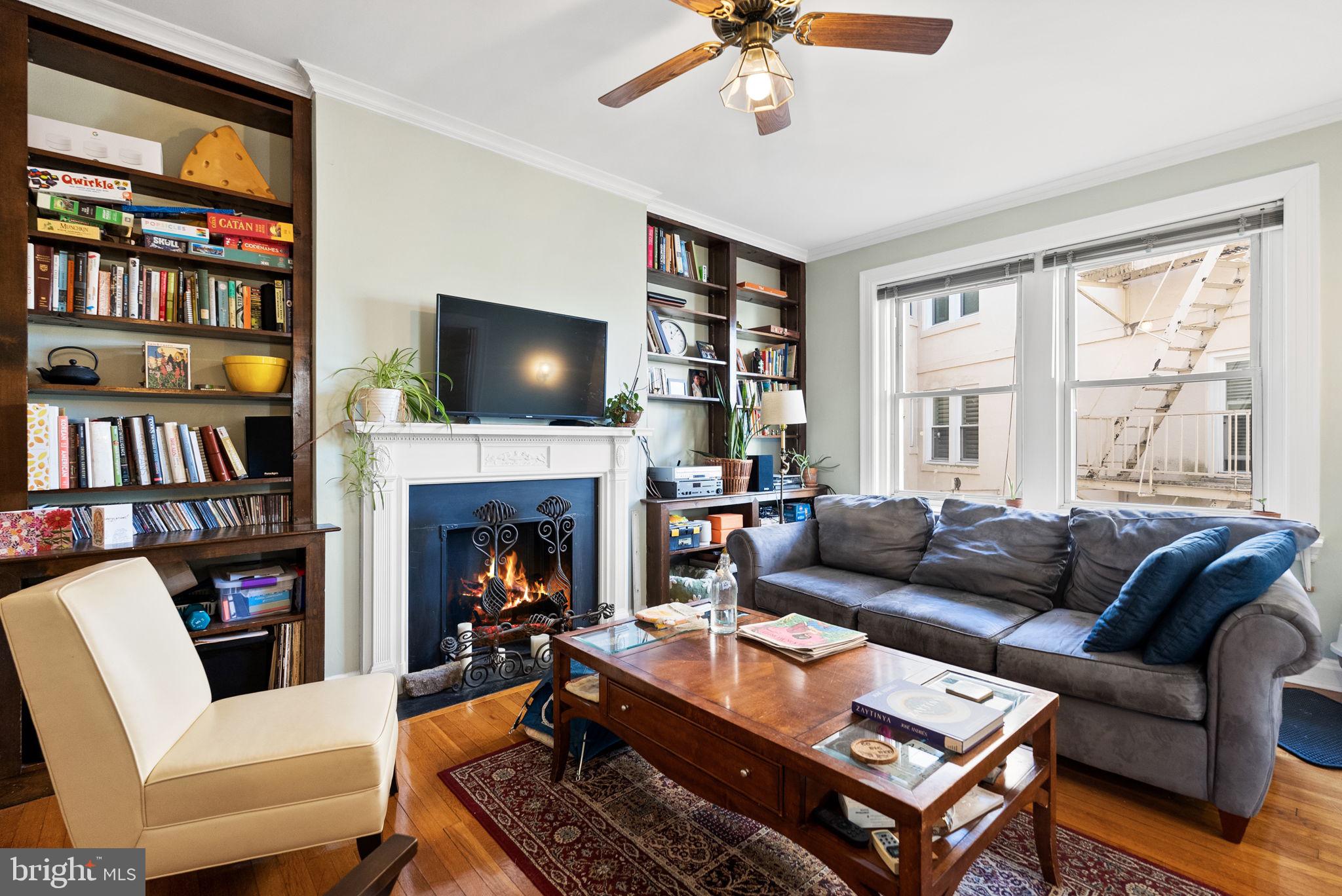 3405 Greenway, Unit 302 Baltimore, MD 21218 - Photo 8 of 42 a living room with furniture a fireplace and a flat screen tv