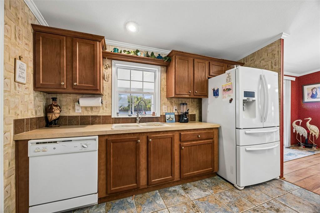 334 Paradise Circle Satsuma, FL 32189 - Photo 16 of 40 a kitchen with a white cabinets and white appliances