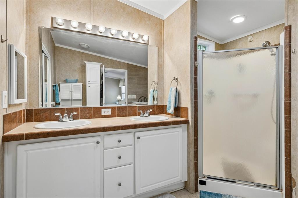 334 Paradise Circle Satsuma, FL 32189 - Photo 20 of 40 a bathroom with a granite countertop sink mirror and a