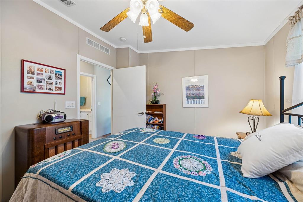 334 Paradise Circle Satsuma, FL 32189 - Photo 23 of 40 a bedroom with a bed and wooden floor
