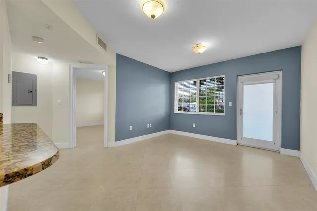 an empty room with windows and entrance