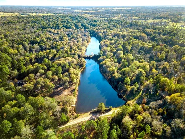 a view of a lake in between two chairs