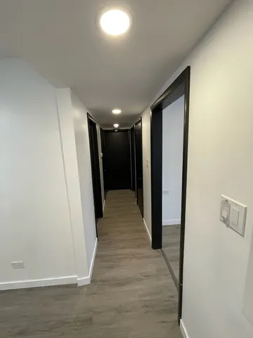 an empty room with wooden floor and a window