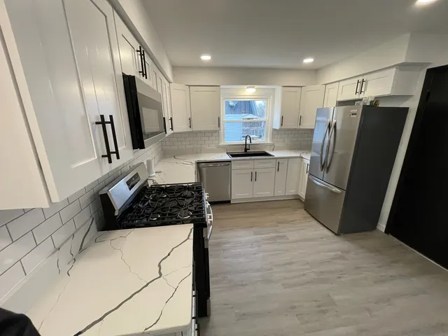 a kitchen with a refrigerator and a sink