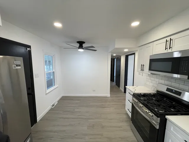 a kitchen with a stove and a refrigerator