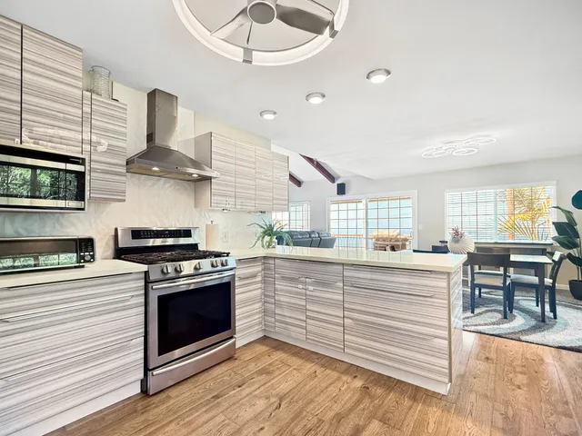 a bedroom with a bed a couch and a large window