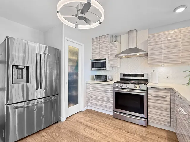 a bedroom with furniture and a large window