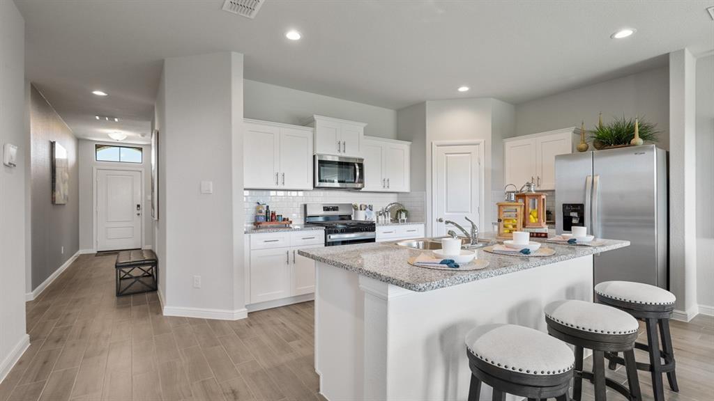 1227 Patti Lane Decatur, TX 76234 - Photo 37 of 39 Kitchen-All Home and community information, including pricing, included features, terms, availability and amenities, are subject to change at any time without notice or obligation. All Drawings, pictures, photographs, video, square footages, floor plans, elevations, features, colors and sizes are approximate for illustration purposes only and will vary from the homes as built.