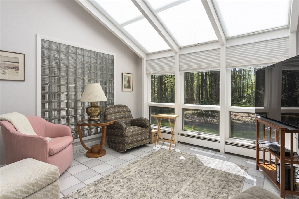 60 Whisper Drive Worcester, MA 01609 - Photo 19 of 39 a living room with furniture a flat screen tv and floor to ceiling window