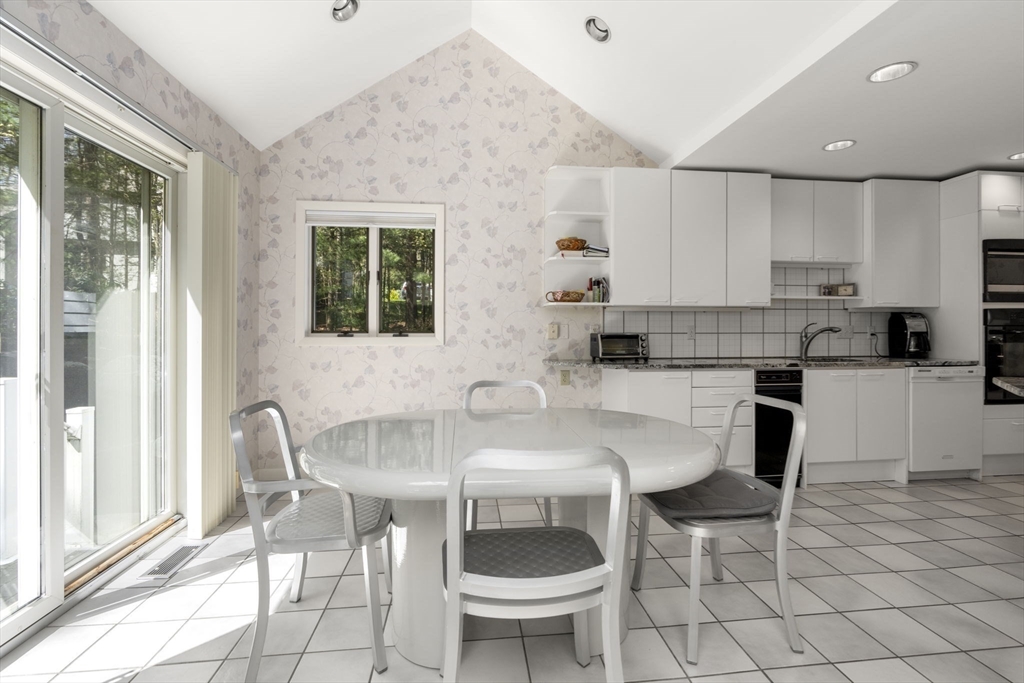 60 Whisper Drive Worcester, MA 01609 - Photo 8 of 39 a kitchen with a dining table chairs and a counter top space