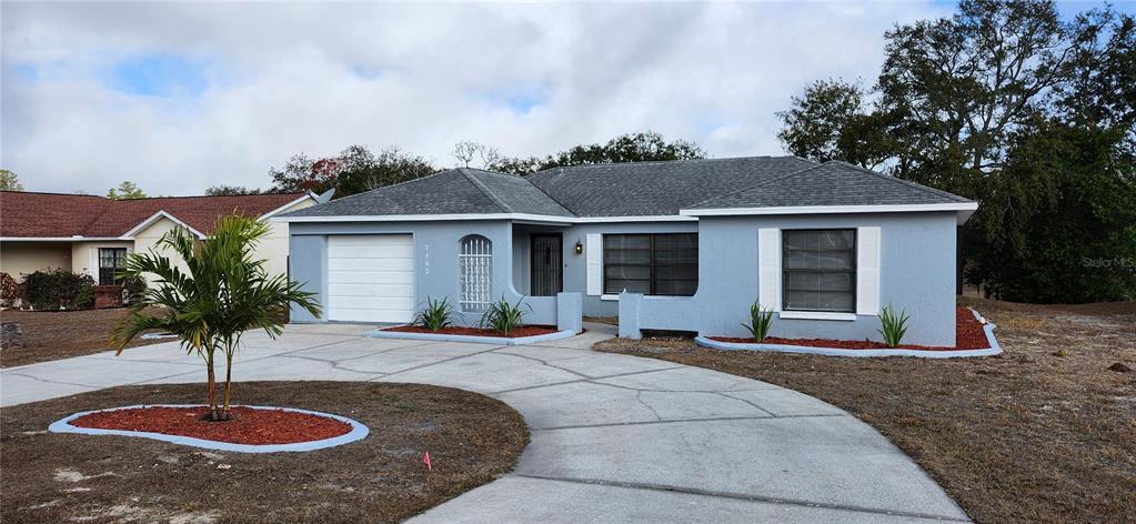 7452 Philatelic Drive Spring Hill, FL 34606 - Photo 24 of 45 a front view of a house with porch yard and outdoor seating