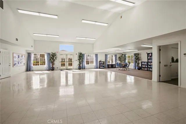 a view of a swimming pool with a lawn chairs and a fire pit