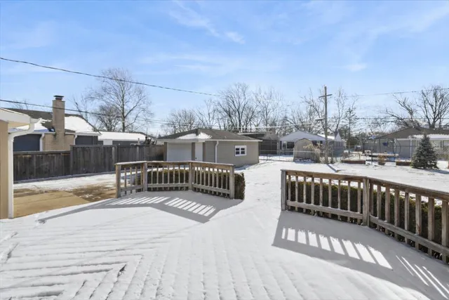 a view of a houses with a yard from a balcony