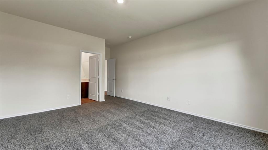 4012 Ripplewood Drive Lindale, TX 75771 - Photo 32 of 37 Spacious room featuring neutral carpeting, light-toned walls, and a recessed ceiling light
