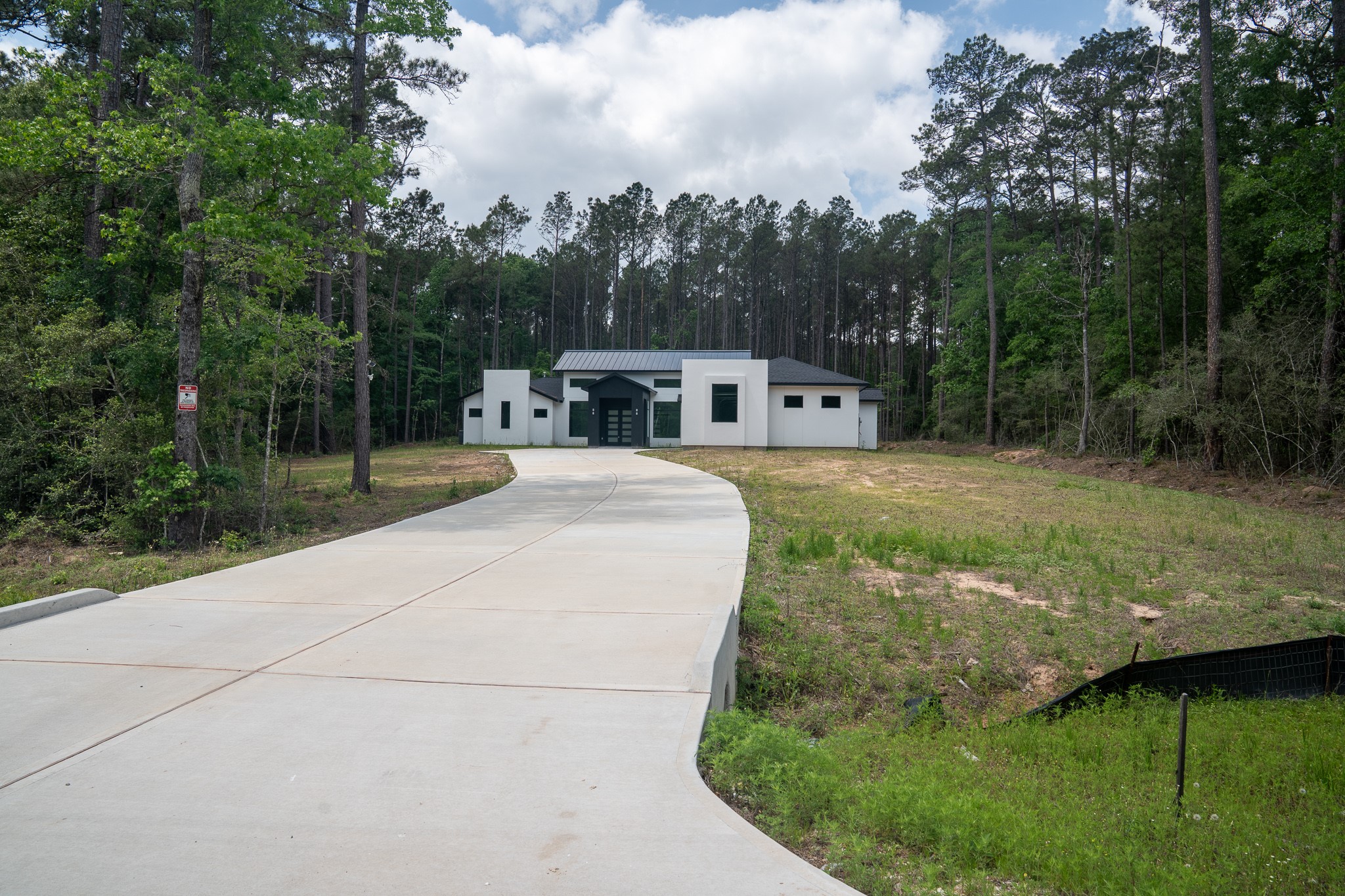 343 Sundog Road Huntsville, TX 77340 - Photo 2 of 37 Situated on a 2-acre wooded lot with an extended driveway.