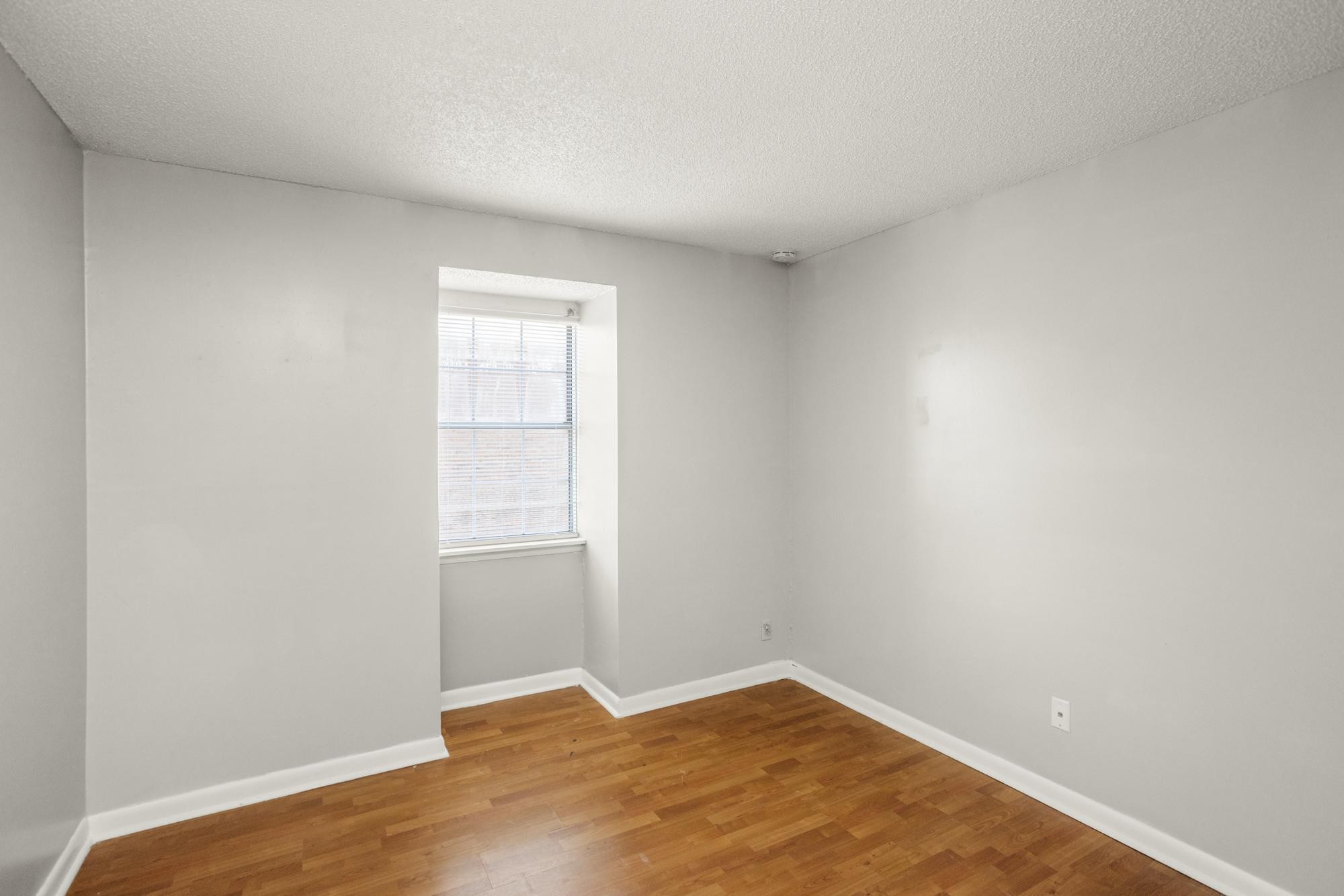 323 Forest Park Road Madison, TN 37115 - Photo 17 of 22 a view of an empty room with wooden floor and a window