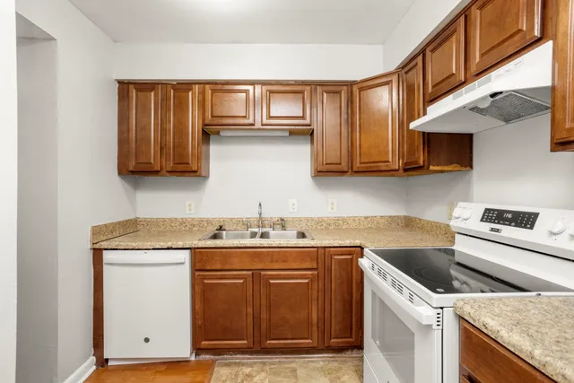 a kitchen with stainless steel appliances granite countertop a sink stove and cabinets