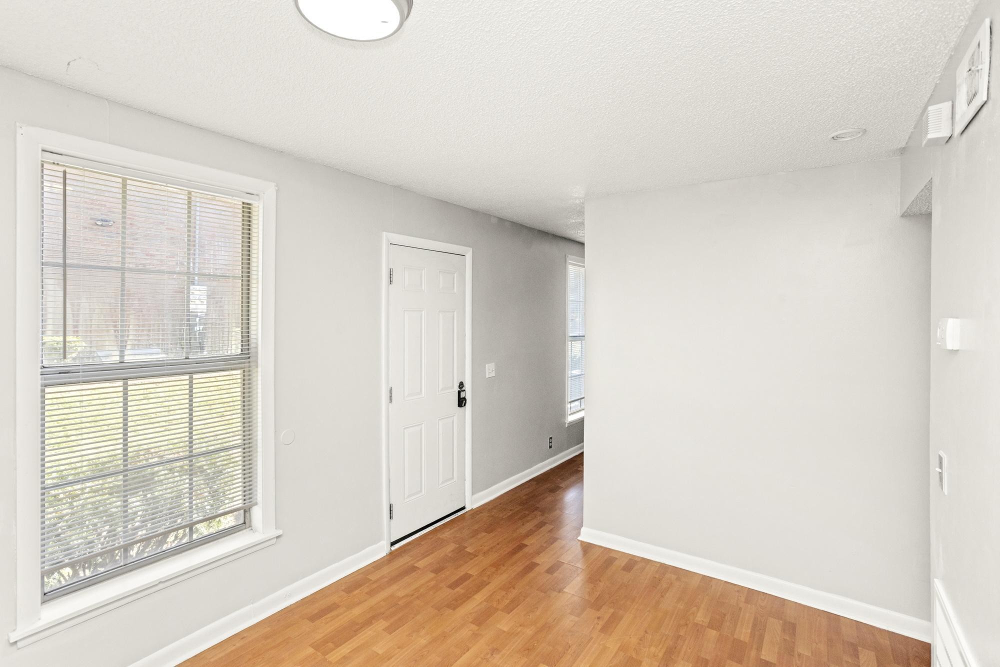 323 Forest Park Road Madison, TN 37115 - Photo 5 of 22 a view of an empty room with wooden floor and a window