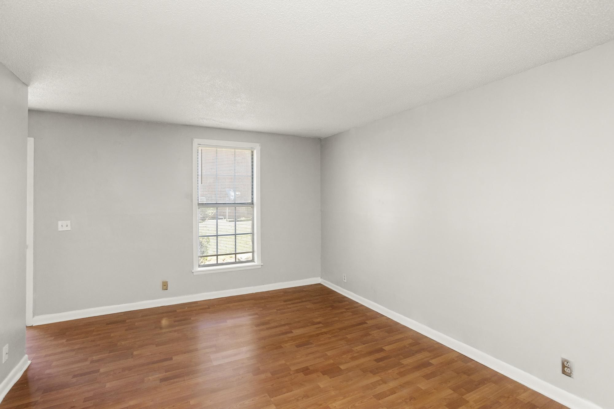 323 Forest Park Road Madison, TN 37115 - Photo 8 of 22 an empty room with wooden floor and window
