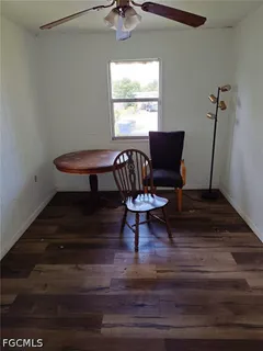 a living room with furniture a window and a potted plant