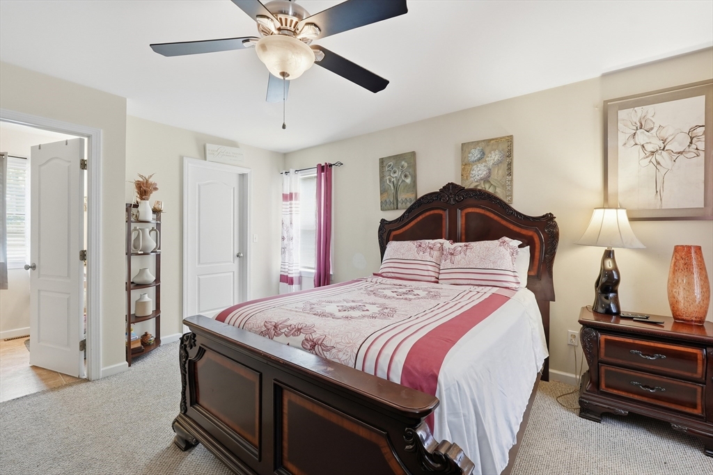 19 Annies Way Springfield, MA 01119 - Photo 17 of 40 a bedroom with a bed and a chandelier