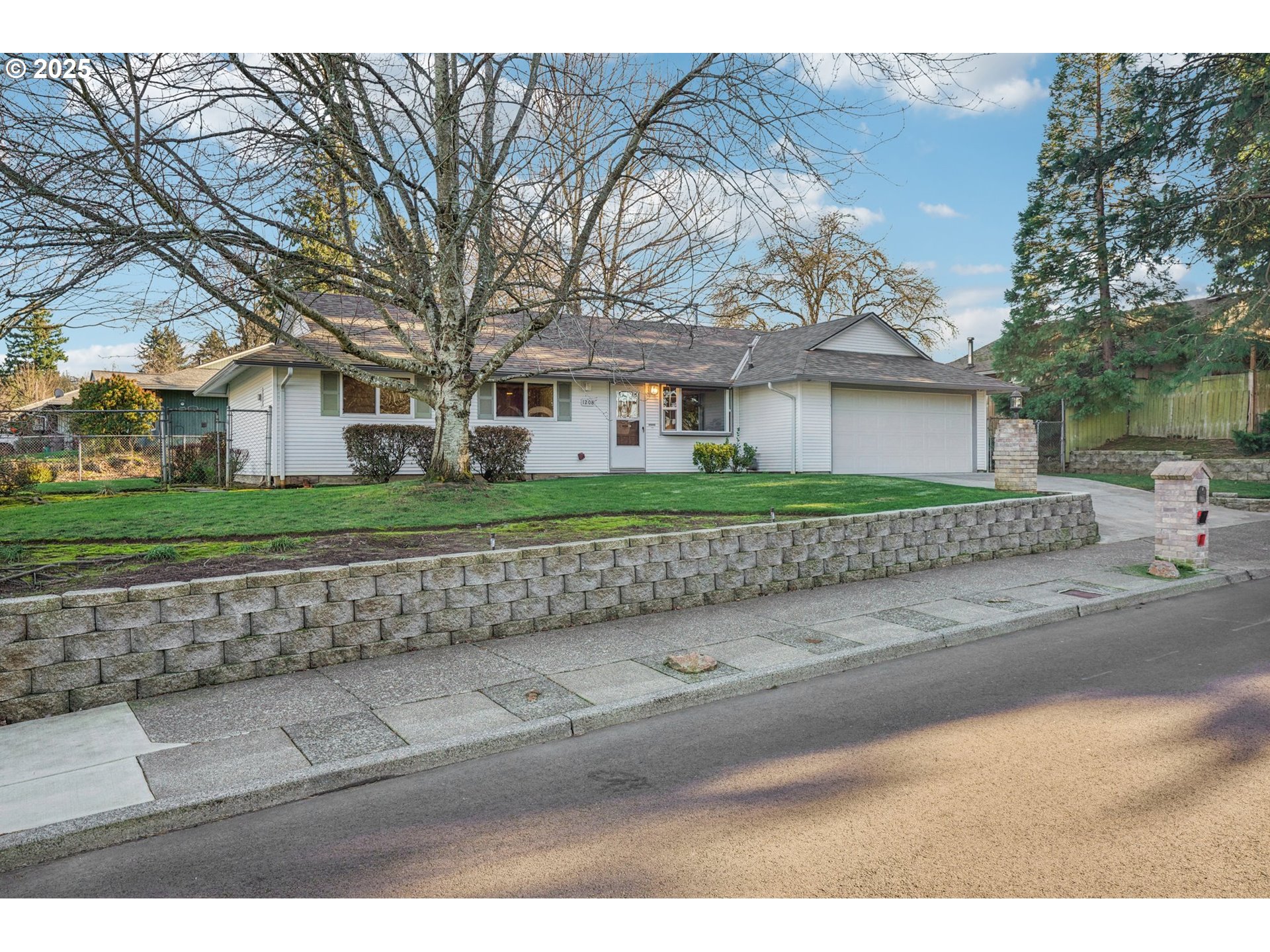 1208 Southeast 209th Avenue Gresham, OR 97030 - Photo 2 of 24 a front view of a house with a yard