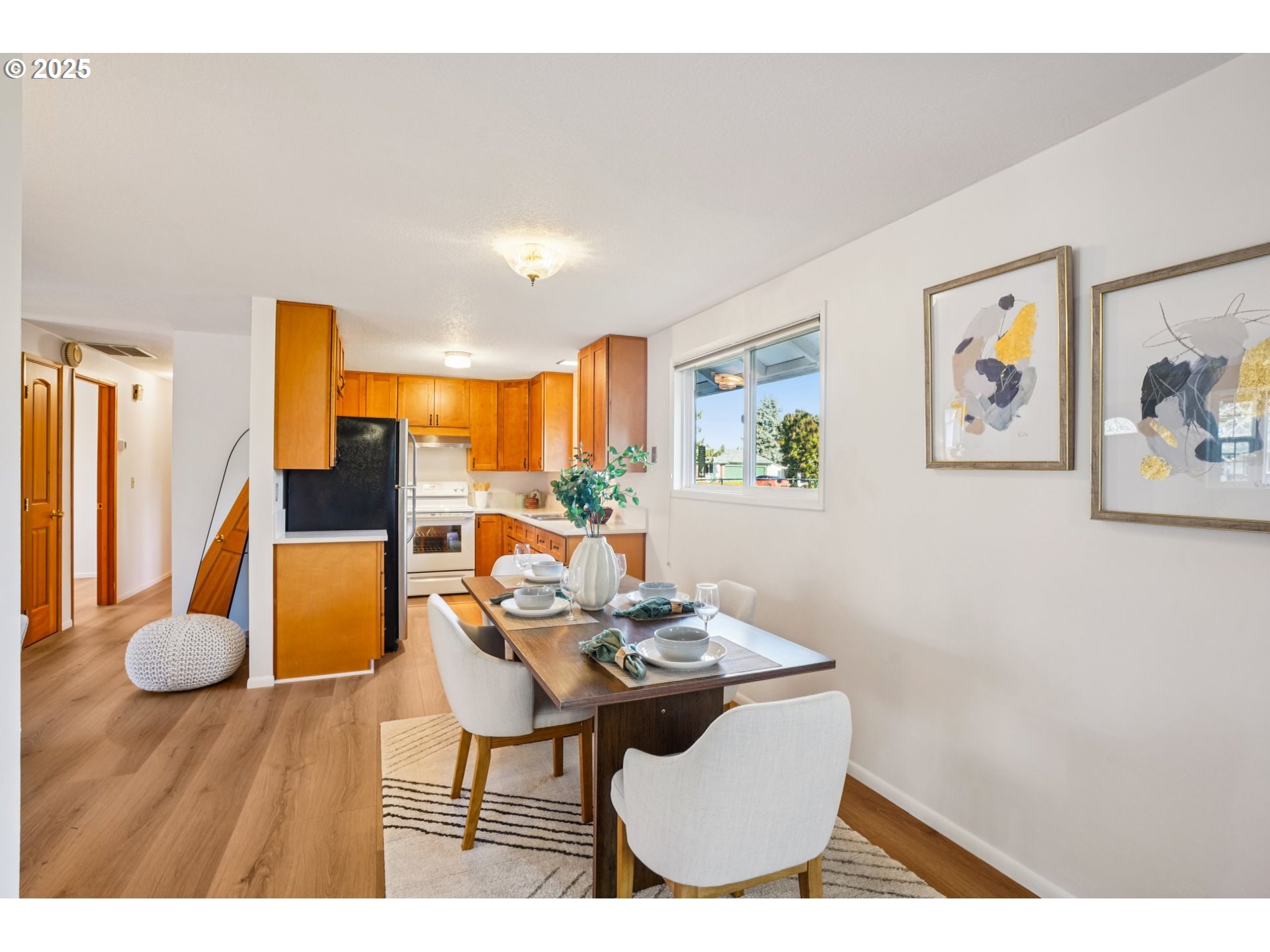 1208 Southeast 209th Avenue Gresham, OR 97030 - Photo 7 of 24 a view of a dining room with furniture and wooden floor