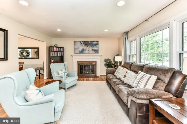 a living room with furniture large window and a fireplace