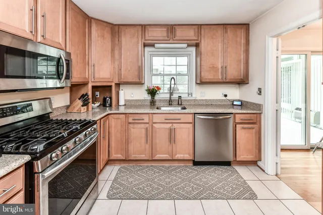 a kitchen with a sink stove top oven and cabinets