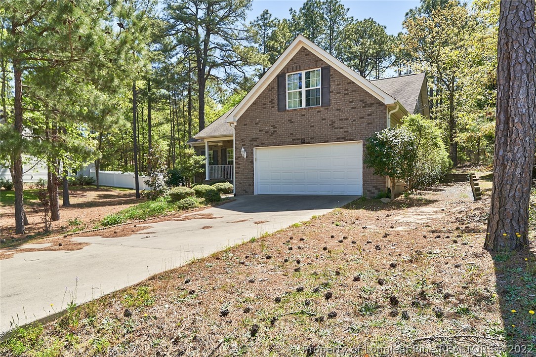 60 Spring Lake Drive Pinehurst, NC 28374 - Photo 2 of 38 a front view of a house with a yard