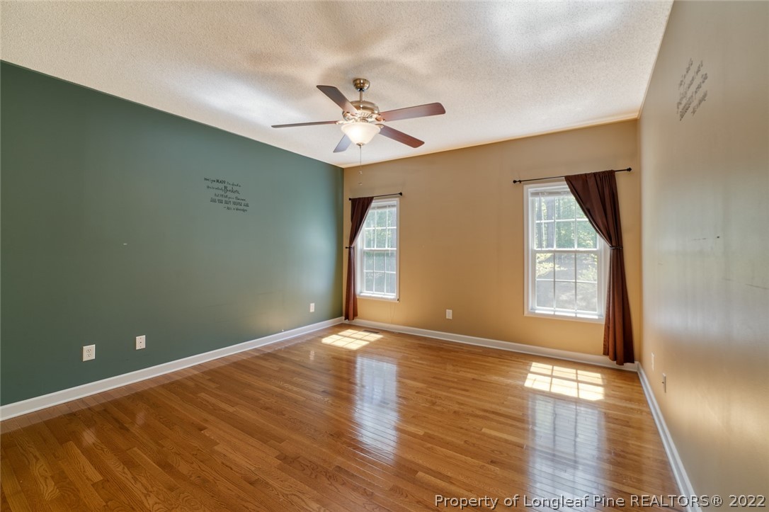 60 Spring Lake Drive Pinehurst, NC 28374 - Photo 21 of 38 a view of an empty room with wooden floor and a window