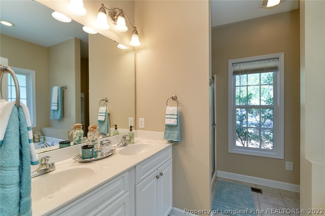 60 Spring Lake Drive Pinehurst, NC 28374 - Photo 23 of 38 a bathroom with a double vanity sink and a mirror